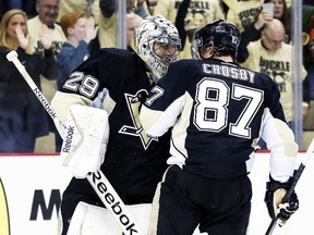 Pittsburgh Penguins goalie Marc-Andre Fleury and centre Sidney Crosby celebrate after defeating the Columbus Blue Jackets in Game 1 of their Eastern Conference quarterfinal series at the Consol Energy Center in Pittsburgh, April 16, 2014. (CHARLES LeCLAIRE/USA Today)