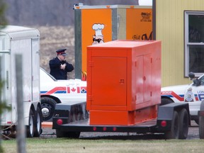 Police at the back of a property on Hamilton Rd. were a three-year-old boy was rushed to hospital after being pulled from a pond in London on Friday. DEREK RUTTAN/The London Free Press/QMI Agency