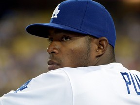 Los Angeles Dodgers right fielder Yasiel Puig watches from the dugout during a game against the San Francisco Giants at Dodger Stadium. (Kirby Lee/USA TODAY Sports)