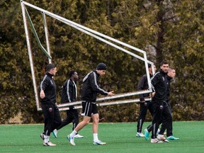 Ottawa Fury FC players carry a net frame prior to a training session at Carleton University. The team plays it's first ever home game on Saturday. April 18,2014. Errol McGihon/Ottawa Sun/QMI Agency