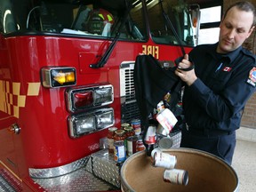 Toronto firefighter Dylan Easby of Station #146 on Jane St. north of Wilson Ave. loads food donated for the Daily Bread Food Bank Friday April 18, 2014. (Dave Thomas/Toronto Sun)