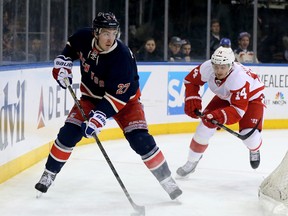 Ryan McDonagh #27 of the New York Rangers takes the puck as Gustav Nyquist #14 of the Detroit Red Wings defends at Madison Square Garden on March 9, 2014 in New York City. (Elsa/Getty Images/AFP)