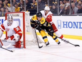 Boston Bruins forward Brad Marchand (63) skates with the puck as Detroit Red Wings defenceman Danny DeKeyser defends during Game 1 of the first-round Stanley Cup playoff series Friday at TD Banknorth Garden. (Greg M. Cooper/USA TODAY Sports)