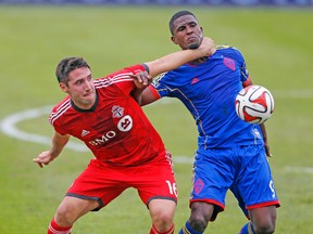 Things get a little rough between TFC’s Bradley Orr and Colorado’s Edison Buddle during last week’s game. (MICHAEL PEAKE/Toronto Sun)