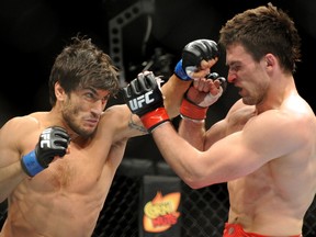 Elias Theodorou, left, tangles with St. Albert's Sheldon Westcott in an MMA bout. (QMI AGENCY/File)