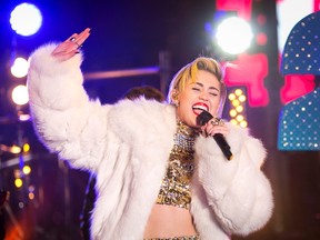 Singer Miley Cyrus performs during New Year's Eve celebrations at Times Square in New York, in this December 31, 2013, file photo. Singer Miley Cyrus cancelled her Tuesday show in Kansas City, Missouri, after being hospitalized for a "severe allergic reaction to antibiotics," the show venue said, April 15, 2014. REUTERS/Carlo Allegri/Files