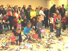 Children search the floor of the Rodney Recreation Centre Saturday looking for Easter eggs.