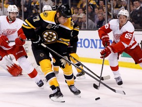 Boston Bruins left wing Milan Lucic (17) battles for the puck with Detroit Red Wings defenseman Danny DeKeyser (65) during the third period in game one of the first round of the 2014 Stanley Cup Playoffs at TD Banknorth Garden on Apr 18, 2014 in Boston, MA, USA. (Greg M. Cooper/USA TODAY Sports)