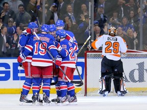The New York Rangers celebrate a goal scored by New York Rangers center Derek Stepan (21) on Philadelphia Flyers goalie Ray Emery (29) during the third period in game one of the first round of the 2014 Stanley Cup Playoffs at Madison Square Garden on Apr 17, 2014 in New York, NY, USA. (Adam Hunger/USA TODAY Sports)
