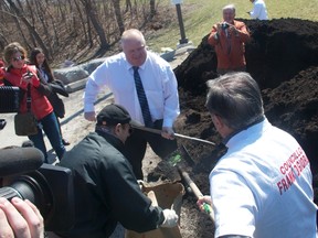 Mayor Rob Ford shovels compost with Councillor Frank Di Giorgio on April 19, 2014. (Maryam Shah/Toronto Sun)