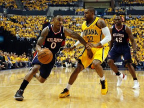 Atlanta Hawks guard Jeff Teague (0) drives to the basket against Indiana Pacers guard C.J. Watson (32) in game one during the first round of the 2014 NBA Playoffs at Bankers Life Fieldhouse on Apr 19, 2014 in Indianapolis, IN, USA. (Brian Spurlock/USA TODAY Sports)