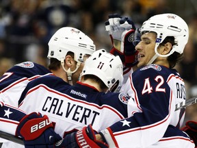 Columbus Blue Jackets defenceman Jack Johnson (left) and centre Artem Anisimov celebrate a goal by left wing Matt Calvert against the Pittsburgh Penguins during Game 2 of their Eastern Conference quarterfinal series at the Consol Energy Center in Pittsburgh, April, 19, 2014. (CHARLES LeCLAIRE/USA Today)