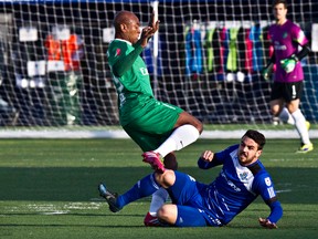 Edmonton's Michael Nonni gets run into by New York's Marcos Antonio Senna da Silva during Friday's game against the New York Cosmos at Clarke Stadium. (Codie McLachlan, Edmonton Sun)