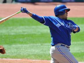 Toronto Blue Jays catcher Dioner Navarro (30) hits a two-run single in the seventh inning against the Cleveland Indians at Progressive Field on April 19, 2014. (DAVID RICHARD/USA TODAY Sports)