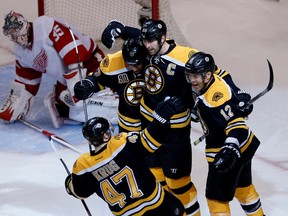 Boston Bruins defenceman Zdeno Chara (33) is congratulated by teammates after scoring a goal on Detroit Red Wings goalie Jimmy Howard (35) during the third period in Game 2 of the first round of the 2014 Stanley Cup Playoffs at TD Banknorth Garden. (Greg M. Cooper-USA TODAY Sports)