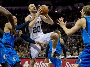 San Antonio Spurs guard Manu Ginobili (20) is fouled by Dallas Mavericks forward Shawn Marion (0) during the second half in game one during the first round of the 2014 NBA Playoffs at AT&T Center on Apr 20, 2014 in San Antonio, TX, USA. (Jerome Miron/USA TODAY Sports)