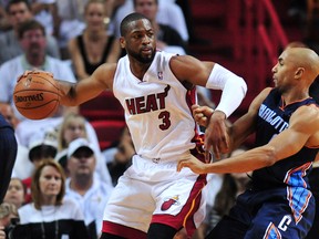 Miami Heat guard Dwyane Wade (3) is pressured by Charlotte Bobcats guard Gerald Henderson (9) during the second half in game one during the first round of the 2014 NBA Playoffs at American Airlines Arena on Apr 20, 2014 in Miami, FL, USA. (Steve Mitchell/USA TODAY Sports)