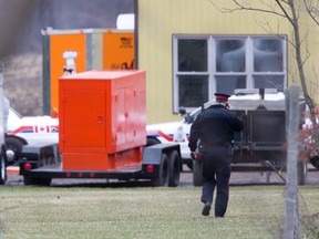 Police at the back of a property on Hamilton Rd. were a three-year-old boy was rushed to hospital after being pulled from a pond in London on Friday. DEREK RUTTAN/The London Free Press/QMI Agency