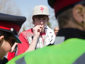 Travis, left, who wouldn?t give his last name, was the only person to smoke marijuana during 420 protests in London?s Victoria Park Sunday. When approached by police, he produced his medicinal marijuana licence and was not arrested. (DEREK RUTTAN, The London Free Press)