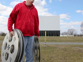 Dan Wannemacher, owner of Kingston Family Fun World, holds a few of the old 35mm movie reels that are now becoming antiques due to the recent change to a digital format. He is in the process of getting the drive-in ready to open next weekend.  (Julia McKay/The Whig-Standard)