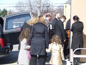 HAROLD CARMICHAEL/SUDBURY STAR
Family members look on as the casket of Fabio Belli is carried by pallbearers into St. Andrew the Apostle Church Saturday.