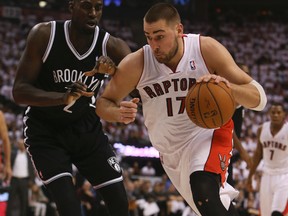 Jonas Valanciunas drives against Kevin Garnett in Game 1 (Veronica Henri, Toronto Sun)