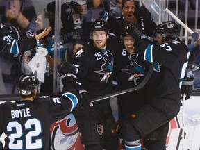 San Jose Sharks center Joe Pavelski (8) is congratulated by defenseman Dan Boyle (22), left wing James Sheppard (15) and center Tommy Wingels (57) for scoring a goal against the Los Angeles Kings during the third period in game two of the first round of the 2014 Stanley Cup Playoffs at SAP Center on April 20, 2014; San Jose, CA, USA  (Kyle Terada/USA TODAY Sports)