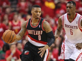 Portland Trail Blazers guard Damian Lillard (0) dribbles the ball as Houston Rockets forward Terrence Jones (6) chases during the second quarter of game one during the first round of the 2014 NBA Playoffs at Toyota Center on Apr 20, 2014 in Houston, TX, USA. (Troy Taormina/USA TODAY Sports)