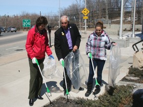 Mayor Dave Canfield lends a helping hand in assisting City of Kenora employee Arleen Wilcox (left) and Harbourtown BIZ representative Michele Livingston of Island Girl boutique in collecting litter along Main Street to launch the Green Leaf Project in Kenora, Wednesday, April 16.