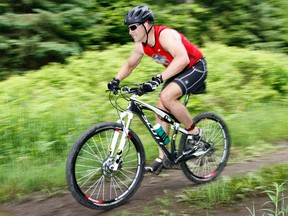 A competitor in the 2012 Surf 'N Turf Relay Race at 8 Wing/CFB Trenton rides hard during the mountain bike leg at Batawa Ski Hill in Quinte West, Ont. This year's edition is slated for Friday, June 6, 2014. - File photo by Jerome Lessard/The Intelligencer/QMI Agency