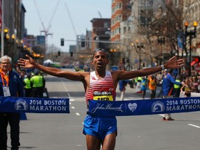 Meb Keflezighi of the U.S. reacts as he wins the men's division at the 118th running of the Boston Marathon in Boston, Massachusetts April 21, 2014. (REUTERS/Brian Snyder)