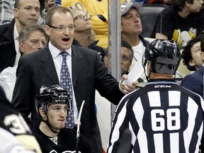 Pittsburgh Penguins head coach Dan Bylsma (top left) reacts to linesman Scott Driscoll (68) after a Penguins goal was disallowed for goal tender interference against the Los Angeles Kings during the third period at the CONSOL Energy Center on Mar 27, 2014 in Pittsburgh, PA, USA. (Charles LeClaire/USA TODAY Sports)