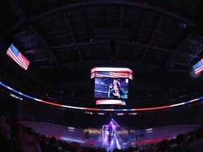 Celena Rae sings the national anthem before a game between the Columbus Blue Jackets and the Dallas Stars at American Airlines Center on April 9, 2014 in Dallas, Texas. (Ronald Martinez/Getty Images/AFP)