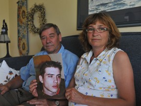 John and Jody Roke pose in their home with a picture of their late son, Matthew. An inquest starts Tuesday to examine the circumstances surrounding the shooting. QMI Agency file photo