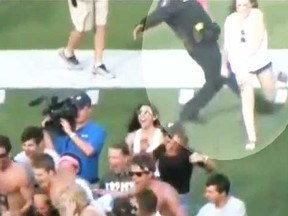 A Georgetown, Tex. cop was caught trying to kick high school students who ran onto the soccer field to celebrate their team's state championship. (YouTube screengrab)