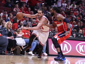Chicago Bulls centre Joakim Noah (13) drives against Washington Wizards forward Nene Hilario (42) during the second half of Game 1 of the first round of the 2014 NBA Playoffs at the United Center. Washington won 102-93. (Dennis Wierzbicki-USA TODAY Sport)