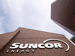 The Suncor Energy sign is seen outside Suncor's head office in Calgary, Alberta, October 2, 2009. Warren Buffett's Berkshire Hathaway Inc took new positions in Canada's Suncor Energy Inc and U.S. satellite TV company Dish Network Corp in the second quarter, a regulatory filing showed August 15, 2013. REUTERS/Todd Korol