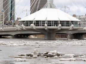 Ice and high water on the Red River flows under the Provencher Bridge in Winnipeg, Man.  Monday April 21, 2014. The river is expected to crest in Winnipeg by Wednesday. (Brian Donogh/Winnipeg Sun/QMI Agency)