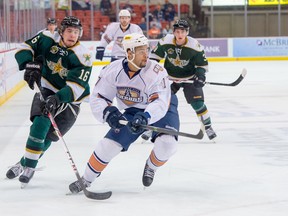 Darnell Nurse challenges a Texas Stars player for the puck during a game between the two teams last Wednesday. (Rob Ferguson, OKC Barons)