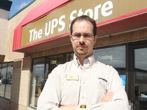 Colin Giesbrecht, owner of the UPS Store on Dakota Street, stands outside his store in Winnipeg, Man. Monday April 21, 2014. Giesbrecht is upset that Manitoba Health did not inform him that a person infected with measles had been in his store. (Brian Donogh/Winnipeg Sun/QMI Agency)