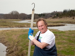 Todd Sleeper collects garbage along the banks of the Thames River near his home northwest of St. Marys, Ontario on Monday April 21, 2014.  Sleeper will be leading the 15th annual Thames River Cleanup this Saturday.
CRAIG GLOVER/The London Free Press/QMI Agency