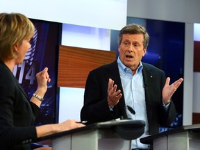 John Tory speaks to Karen Stintz during the mayoral debate at CityTV in Toronto, Ont. on Wednesday March 26, 2014. Dave Abel/Toronto Sun/QMI Agency