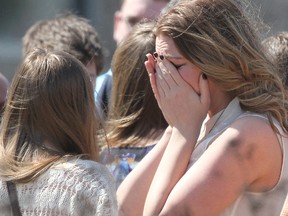 Mourners cry outside First Alliance Church Monday, April 21 where a memorial service for Kaiti Perras was held. Perras was among the five victims of Tuesday's mass murder in Brentwood. Also laid to rest Monday were Jordan Segura and Josh Hunter.  Al Charest/Calgary Sun/QMI Agency