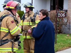 Firefighters attend the scene at a morning house fire on Vancouver Street in London. (DEREK RUTTAN, The London Free Press)