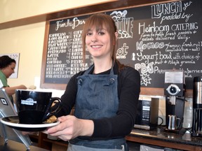 Locomotive Espresso employee Sarah Cox serves up coffee at the new café on the corner of Paul Mall and Colborne Streets. CHRIS MONTANINI\LONDONER\QMI AGENCY