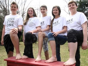 This quintet of Queen Elizabeth II school students in Petrolia, near Sarnia, Ont., will be shunning socks and shoes April 29 as they raise awareness about what impoverished people around the world who can't afford footwear endure. The Grade 8 students are holding a One Day Without Shoes event and will be walking barefoot along Petrolia sidewalks. They're hoping the awareness project spurs goodwill initiatives throughout Sarnia-Lambton. Pictured Monday April 21, 2014, are Mason Hyde, left, Jenna Bezanson, Noah Lefebvre, MacKenzie Limb, and Billy Bourne. TYLER KULA/ THE OBSERVER/ QMI AGENCY