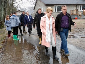Ontario Premier Kathleen Wynne and Mayor of Belleville Neil Ellis leave Derrick Swoffer's property on River Road in Corbyville, Ont. during a tour of flooded areas north of Belleville, Ont. Tuesday, April 22, 2014. - Jerome Lessard/The Intelligencer/QMI Agency