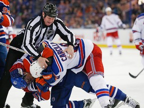 Edmonton Oilers forward David Perron and New York Rangers forward Dan Carcillo fight during the third period at Rexall Place. (Perry Nelson/USA TODAY Sports)