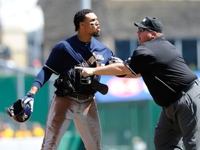 Brewers' Carlos Gomez is restrained by umpire Fieldin Culbreth during the third inning against the Pirates in Pittsburgh on Sunday, April 20, 2014. (Joe Sargent/Getty Images/AFP)