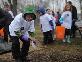 Wyatt Dalmple picks up a piece of garbage at Kingston's Victoria Park on Tuesday. Dalmple and fellow students from Martello Enrichment School picked up garbage and sticks littered though out Victoria Park for Earth Day. 
Justin Greaves/For The Whig-Standard